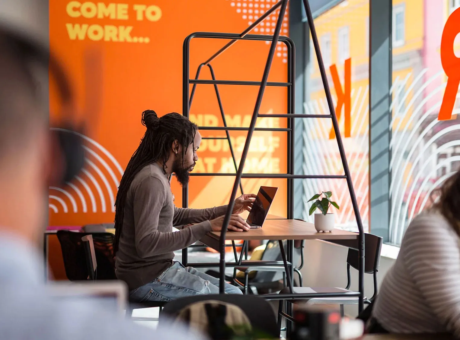 A member working at the tall desks by the Tontine Street window